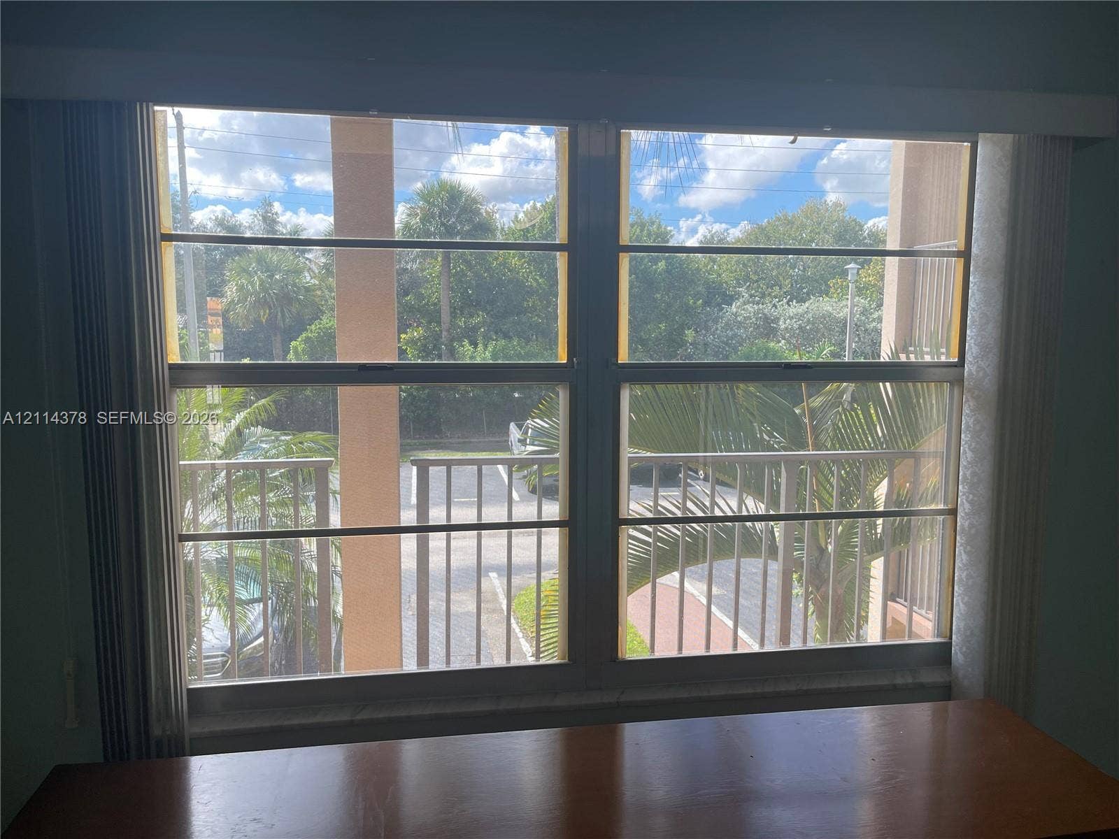 13355 SW 16th Court, #205E, Pembroke Pines, FL 33027 Large dual-pane window featuring a horizontal slider mechanism and metal balcony railing
