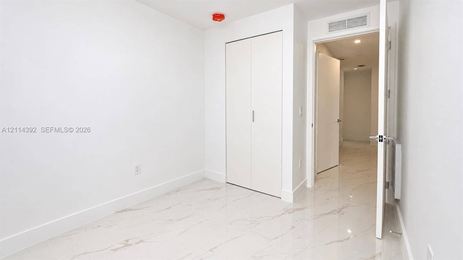 Stone-finish flooring, dual-panel closet doors, and recessed ceiling lighting