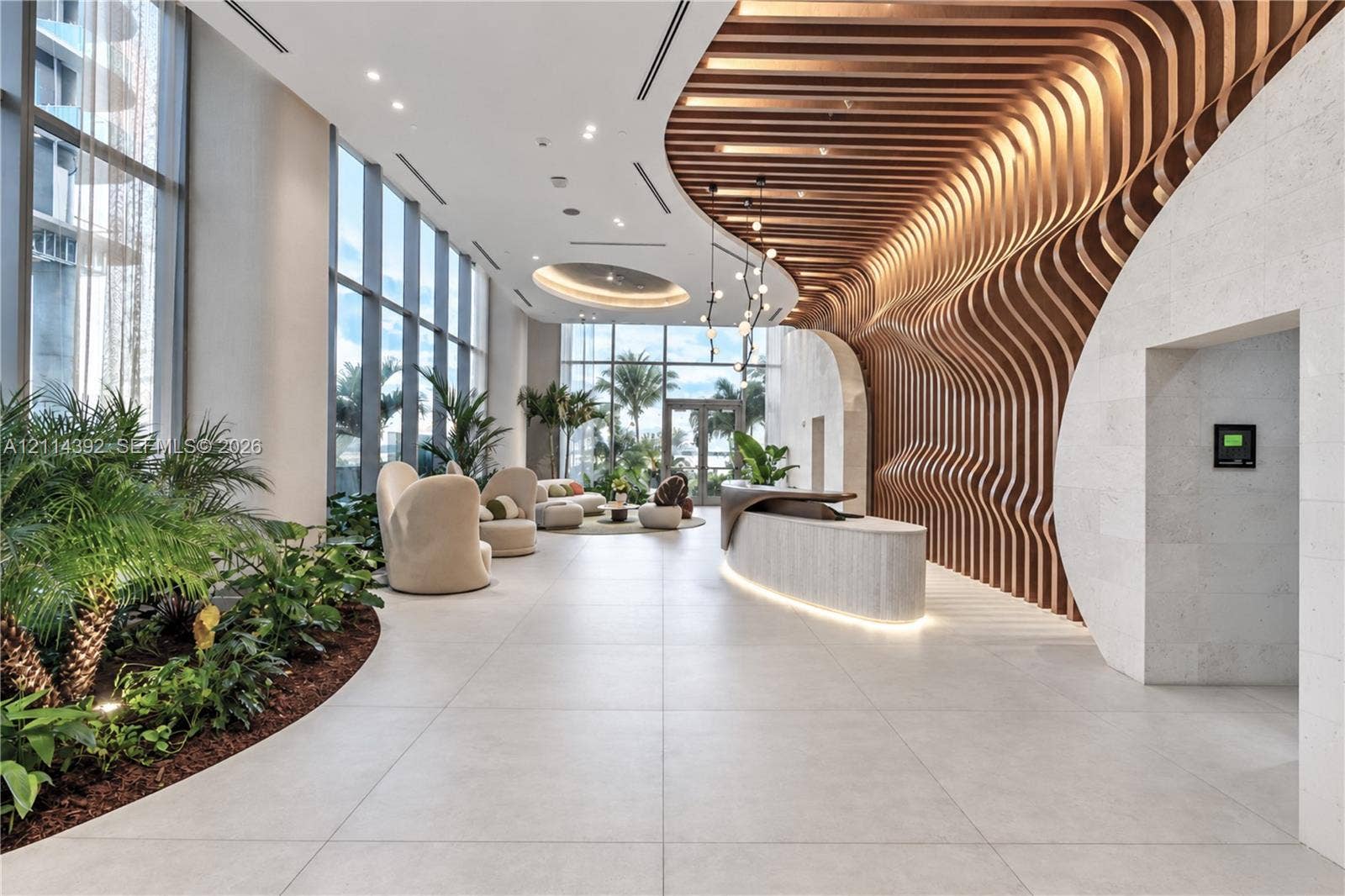 Lobby featuring large-scale floor-to-ceiling windows, parametric wood-slat ceiling detailing, stone-clad walls, large-format tile flooring, and integrated ambient lighting