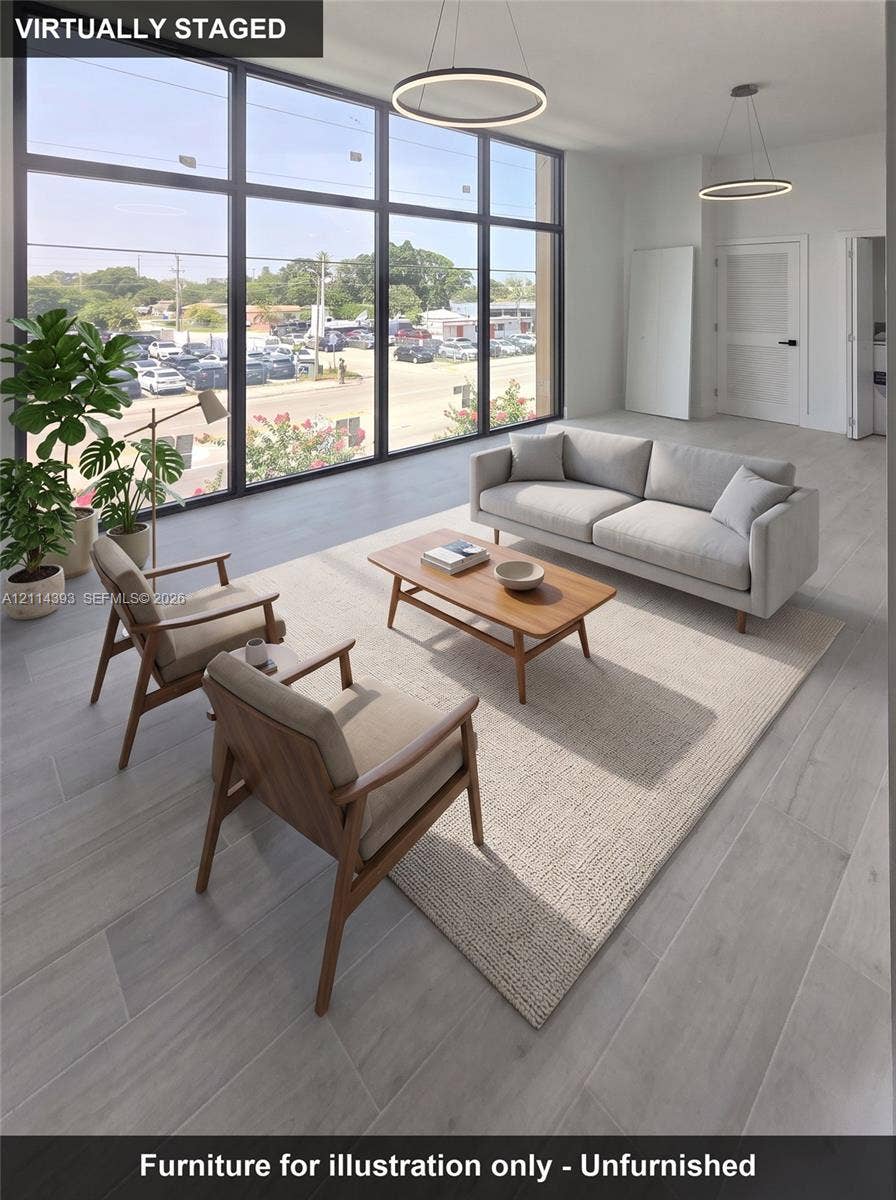 401 Pembroke Road, #202, Hallandale Beach, Hallandale Beach, FL 33009 Floor-to-ceiling windows, wood-finish tile flooring, and minimalist circular pendant lighting