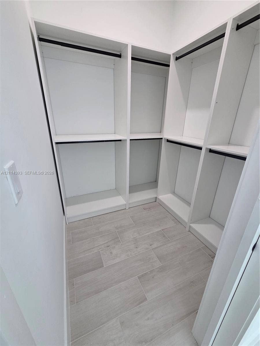 401 Pembroke Road, #202, Hallandale Beach, Hallandale Beach, FL 33009 Custom white built-in shelving, integrated hanging rods, and wood-finish tile flooring