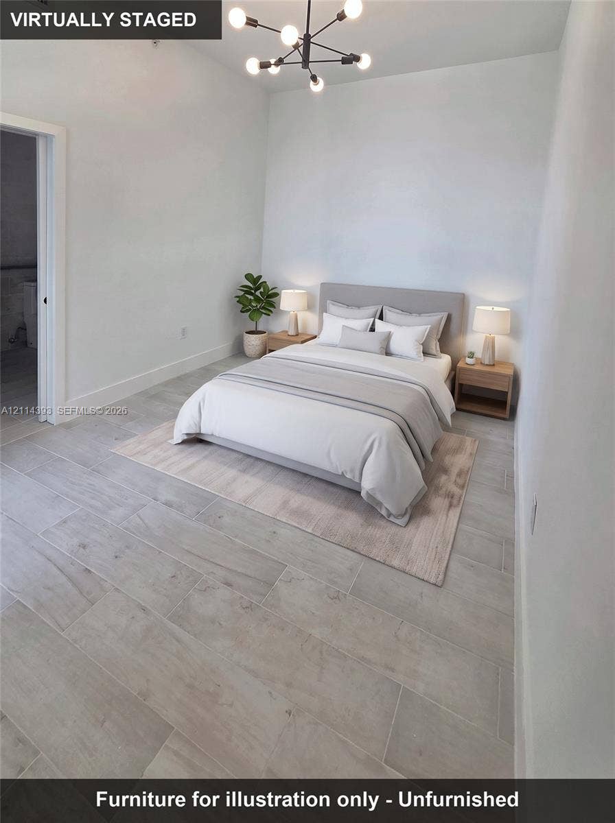 401 Pembroke Road, #202, Hallandale Beach, Hallandale Beach, FL 33009 High-ceiling room featuring neutral paint, wood-finish flooring, and a modern multi-arm light fixture