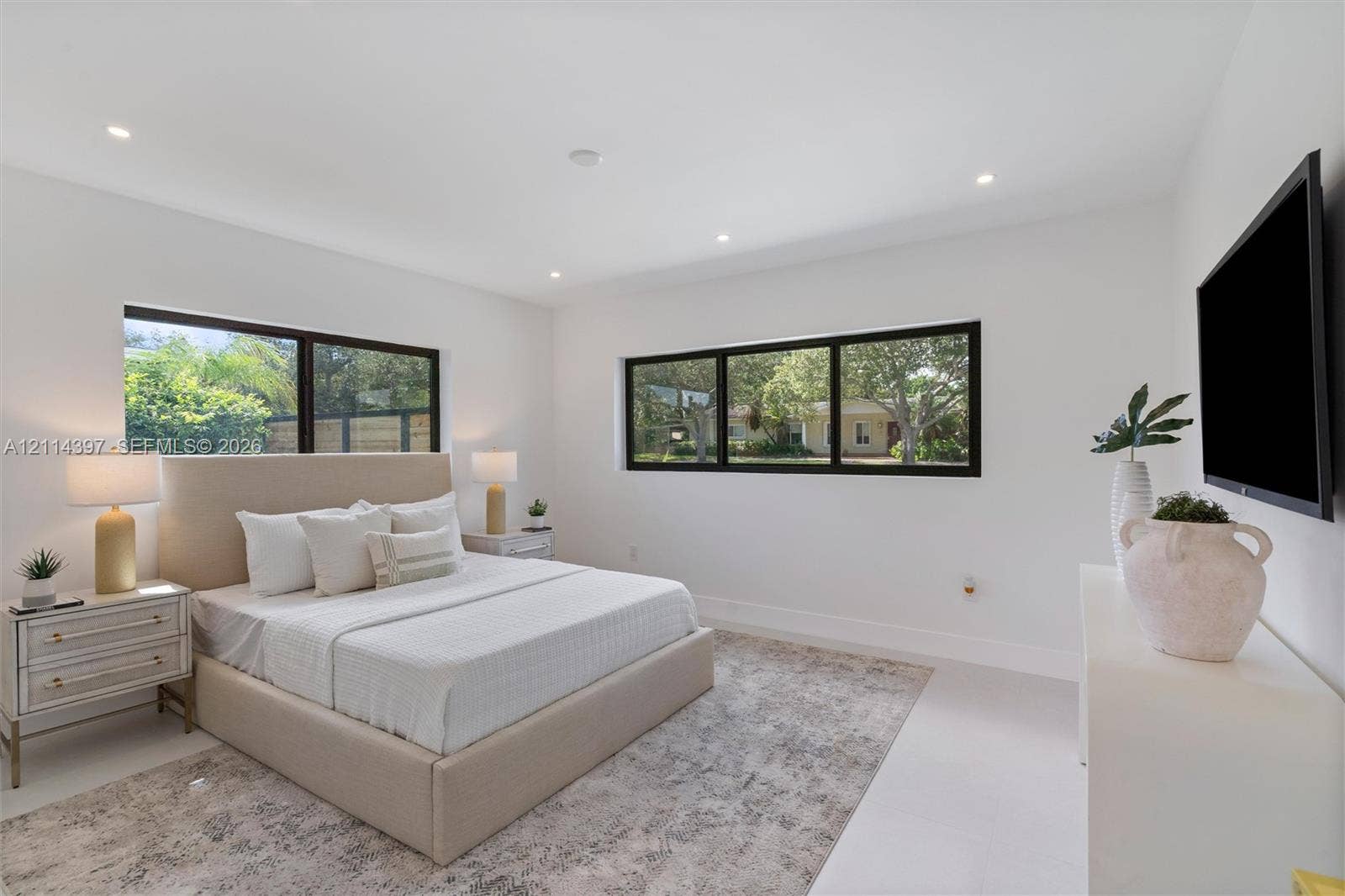 14421 SW 85th Avenue, Palmetto Bay, FL 33158 Bedroom featuring large windows with black frames, recessed ceiling lighting, and smooth-finish flooring