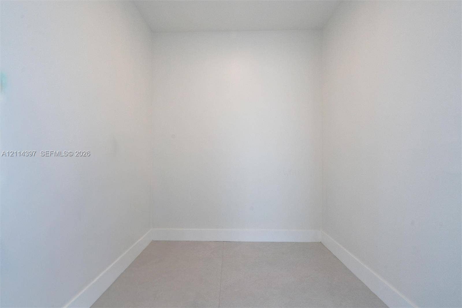 14421 SW 85th Avenue, Palmetto Bay, FL 33158 Interior space featuring neutral wall tones and large-format tile flooring