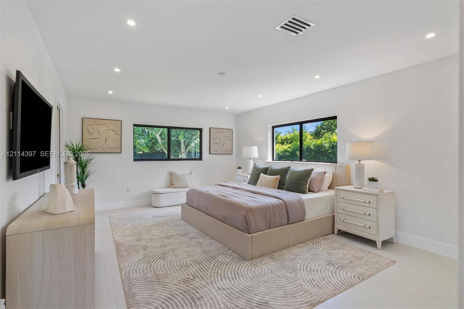 14421 SW 85th Avenue, Palmetto Bay, FL 33158 Neutral interior space featuring recessed ceiling lighting, large black-framed windows, and light-toned flooring