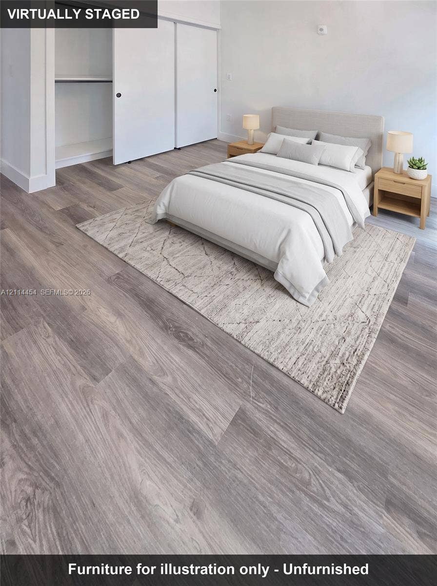 401 Pembroke Road, #203, Hallandale Beach, Hallandale Beach, FL 33009 Neutral-toned wood-finish flooring and sliding-door closet with shelving