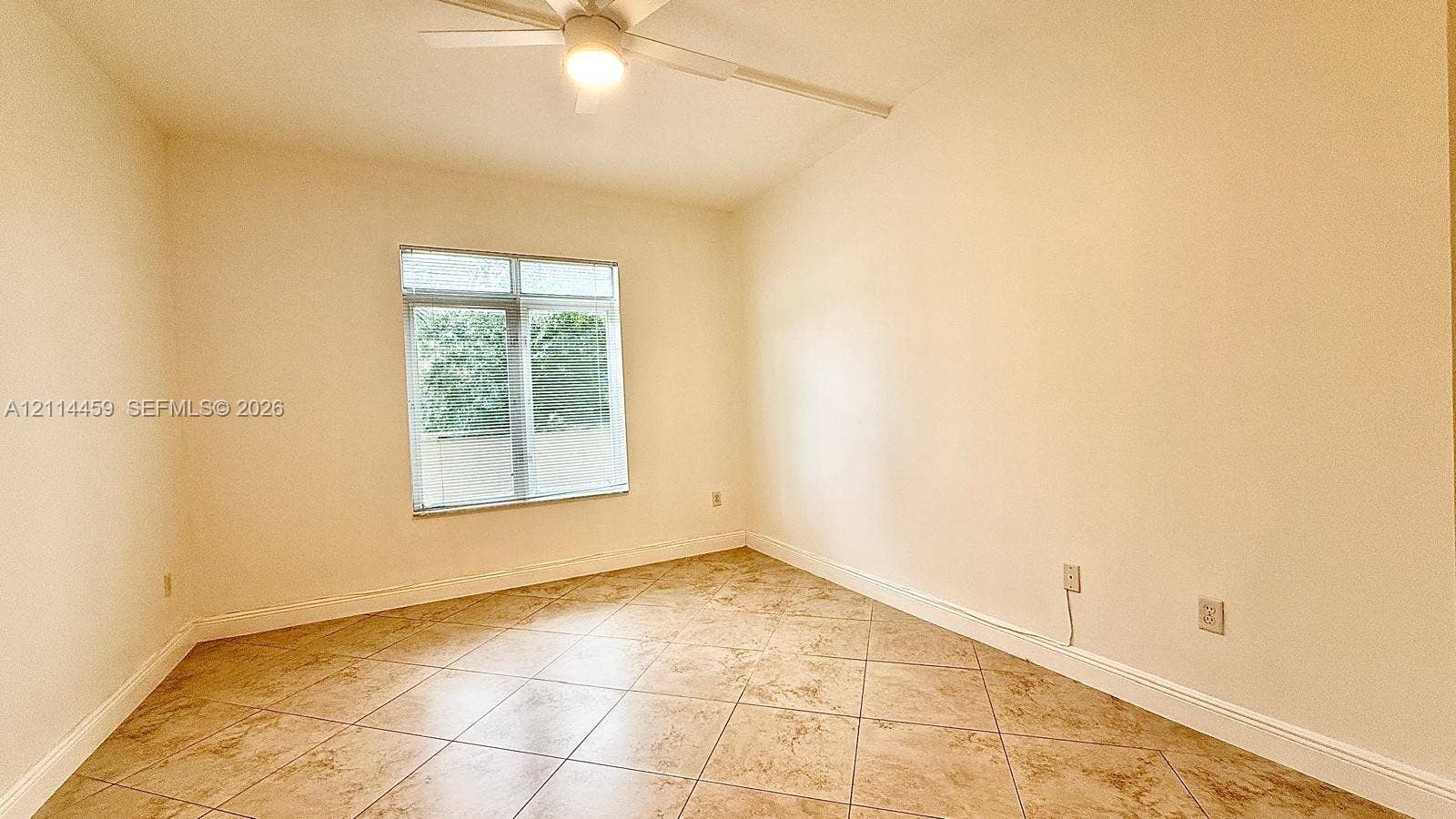 1203 Town Center Drive, #207, Jupiter, Jupiter, FL 33458 Interior room featuring diagonal-set tile flooring, a ceiling fan with integrated lighting, and a multi-pane window