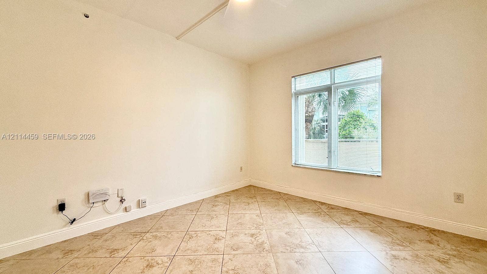 1203 Town Center Drive, #207, Jupiter, Jupiter, FL 33458 Interior room featuring neutral wall paint, tile flooring, and a window with a transom light