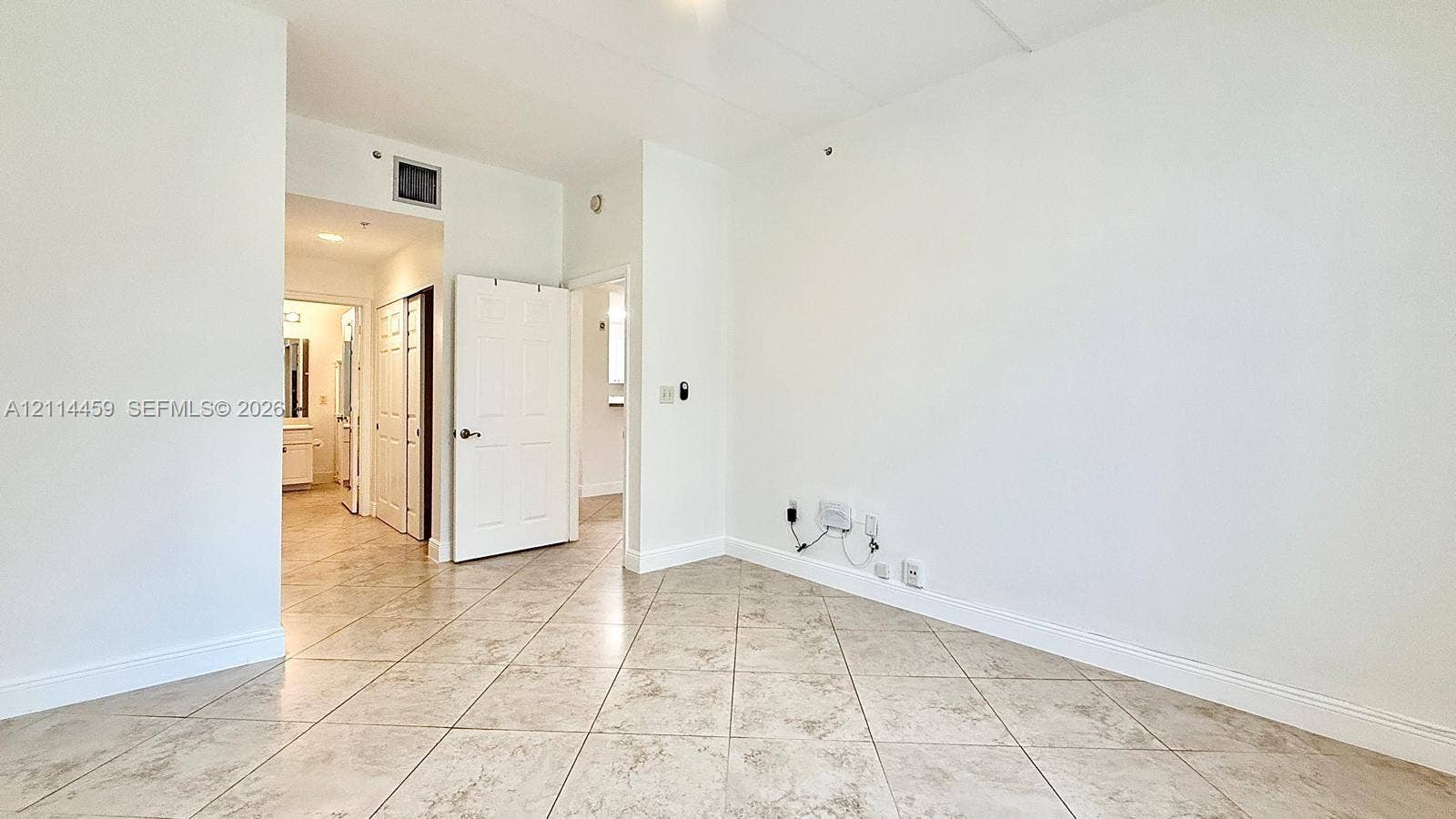 1203 Town Center Drive, #207, Jupiter, Jupiter, FL 33458 Neutral-toned tile flooring set in a diagonal pattern, white six-panel interior doors, and recessed ceiling lighting