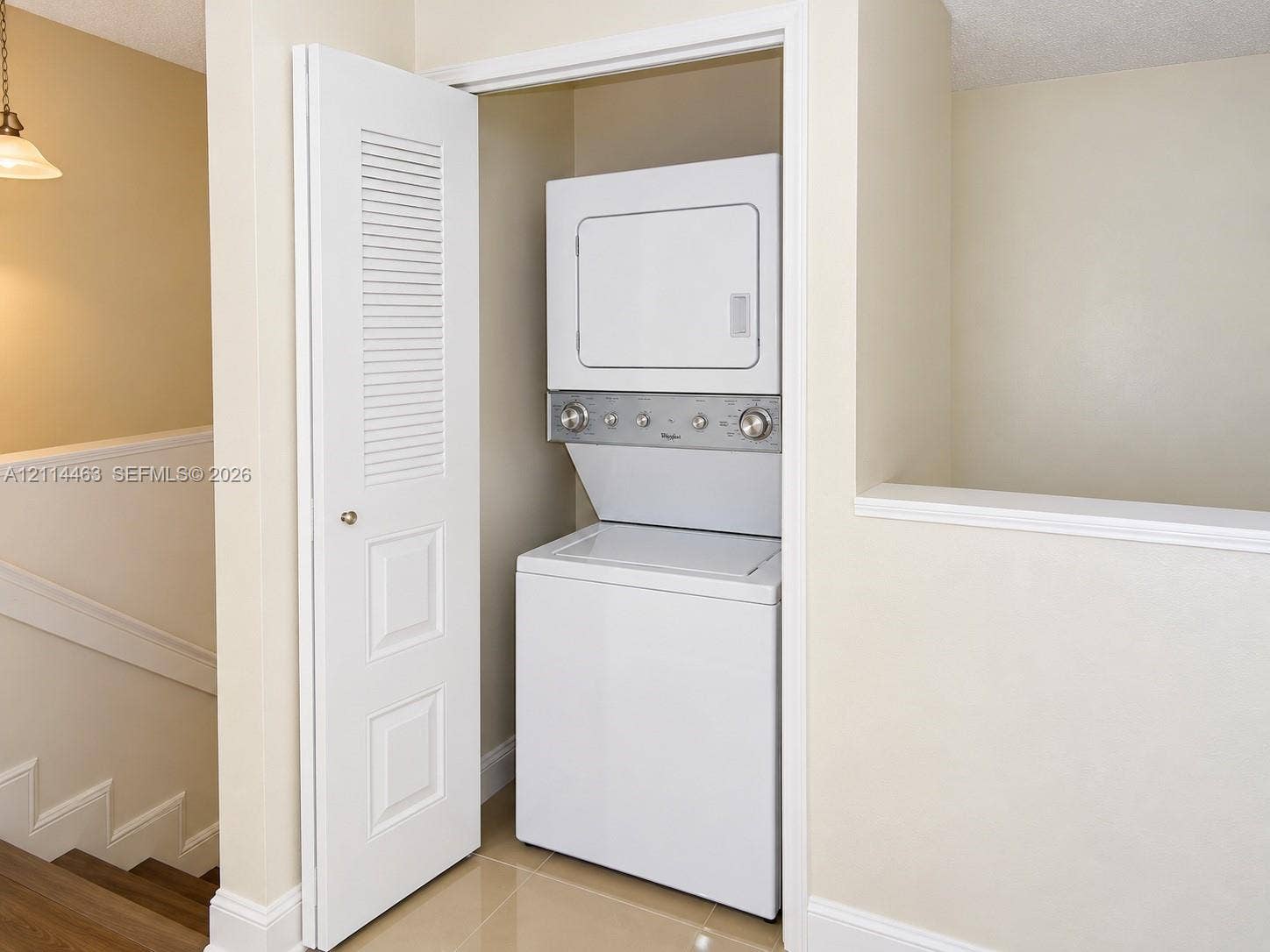 4970 NW 97th Place, #309, Doral, Doral, FL 33178 Laundry closet featuring a white stacked washer and dryer unit and a white louvered panel door