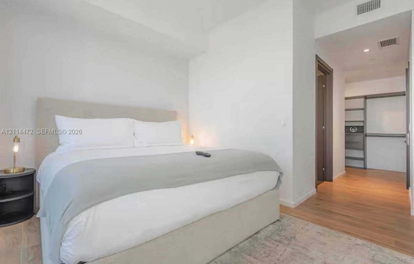 398 NE 5th Street, #4001, Miami, FL 33132 Interior space featuring wood-finish flooring, recessed lighting, and a walk-in closet with built-in shelving