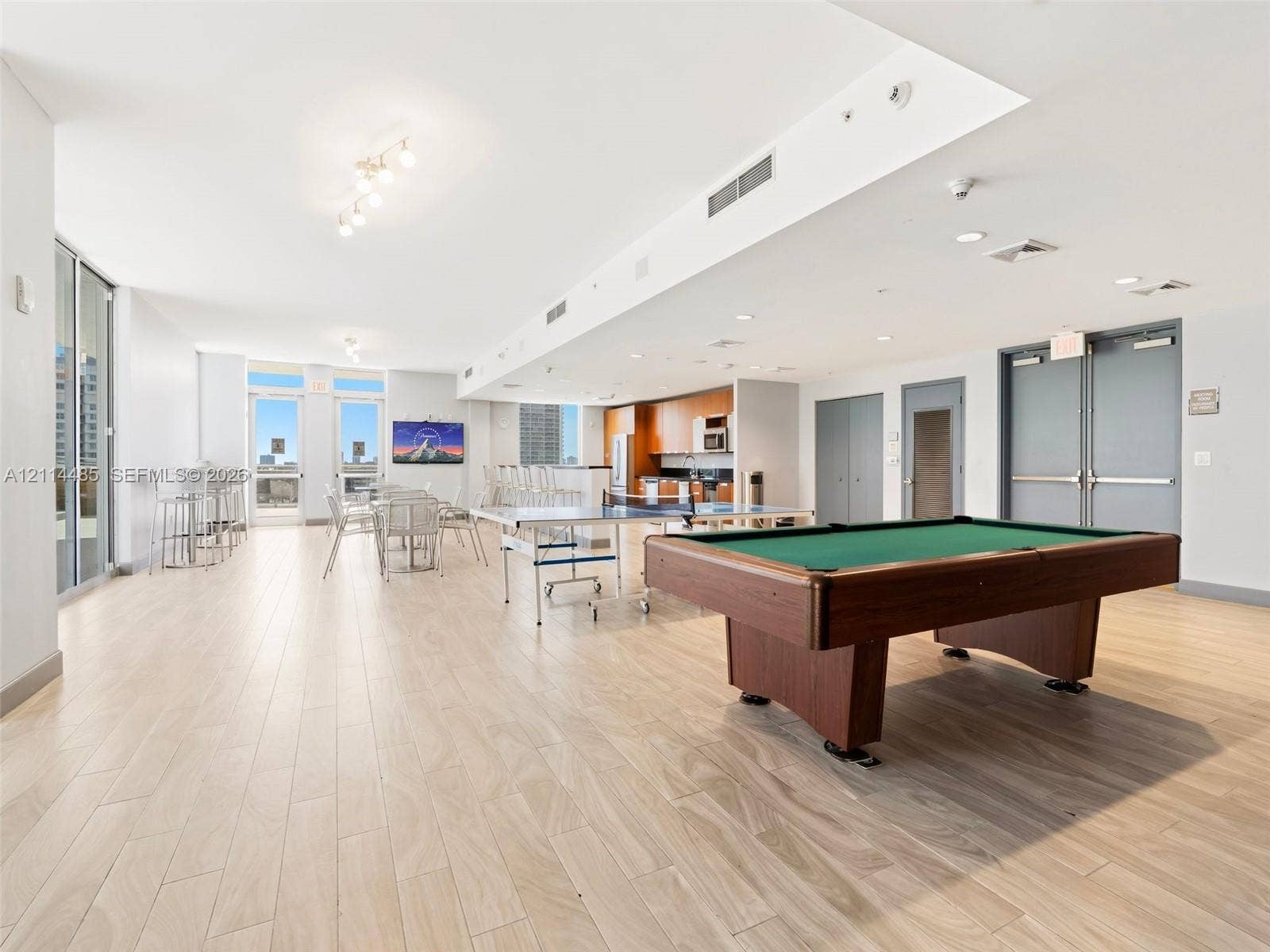 Open-concept floor plan featuring wood-finish flooring, recessed lighting, and expansive floor-to-ceiling glass doors