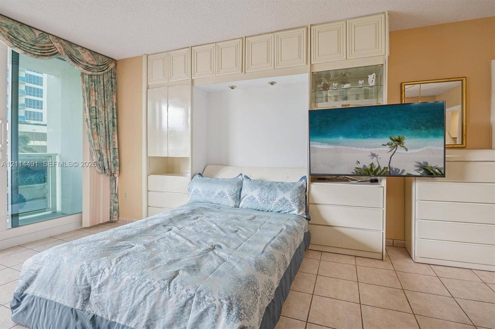 3505 S Ocean Drive, #217, Hollywood, FL 33019 Built-in floor-to-ceiling cabinetry, recessed lighting, tile flooring, and sliding glass door with balcony access