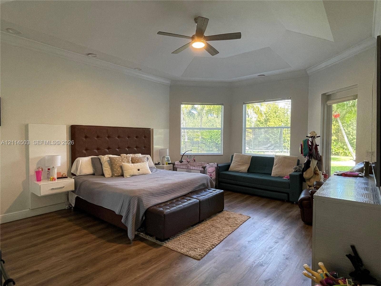 15001 SW 33rd Street, Davie, FL 33331 Tray ceiling with recessed lighting, wood-finish flooring, and built-in floating bedside tables