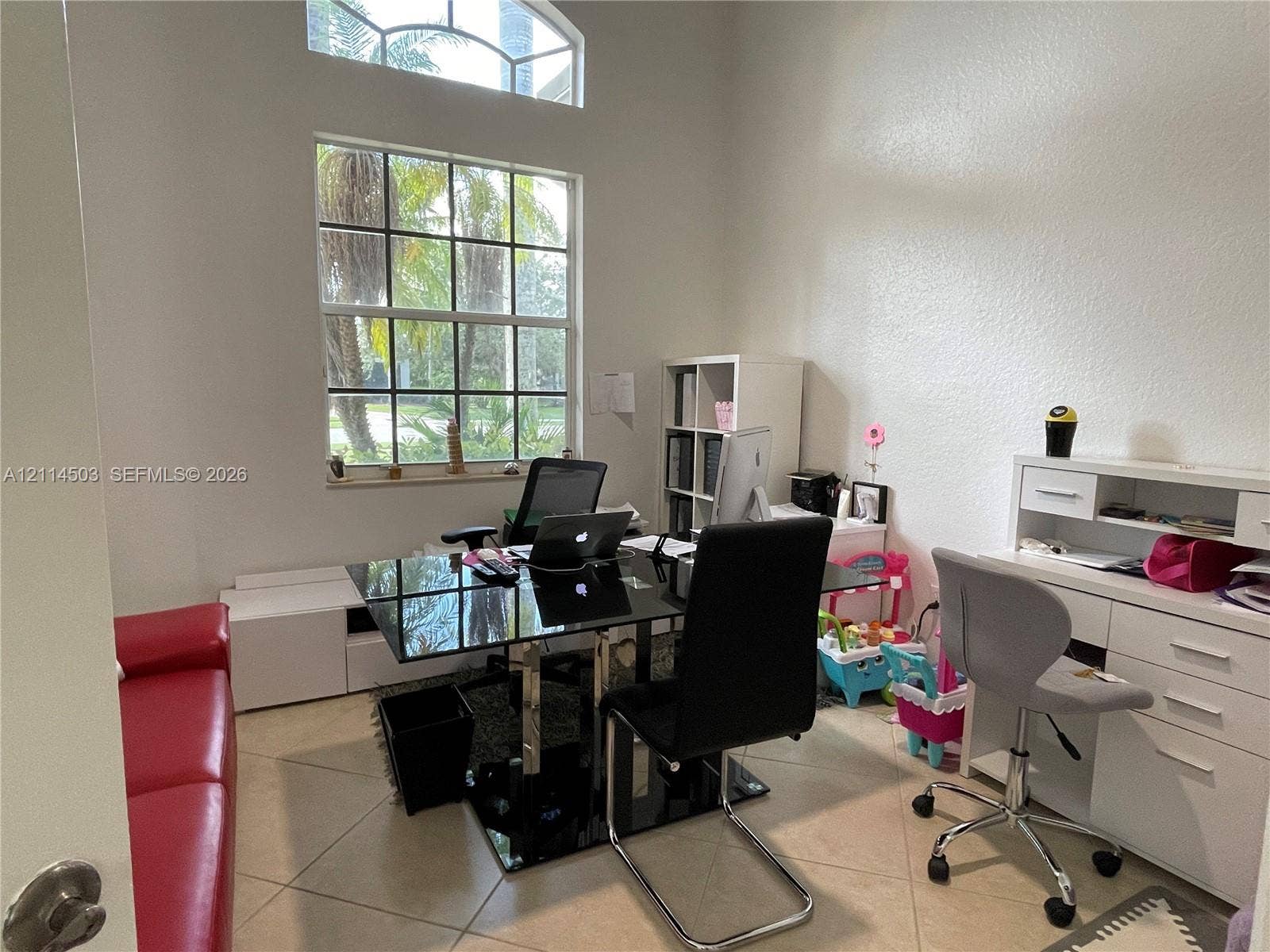 15001 SW 33rd Street, Davie, FL 33331 High ceilings with a prominent arched transom window, grid-pattern windows, and neutral tile flooring