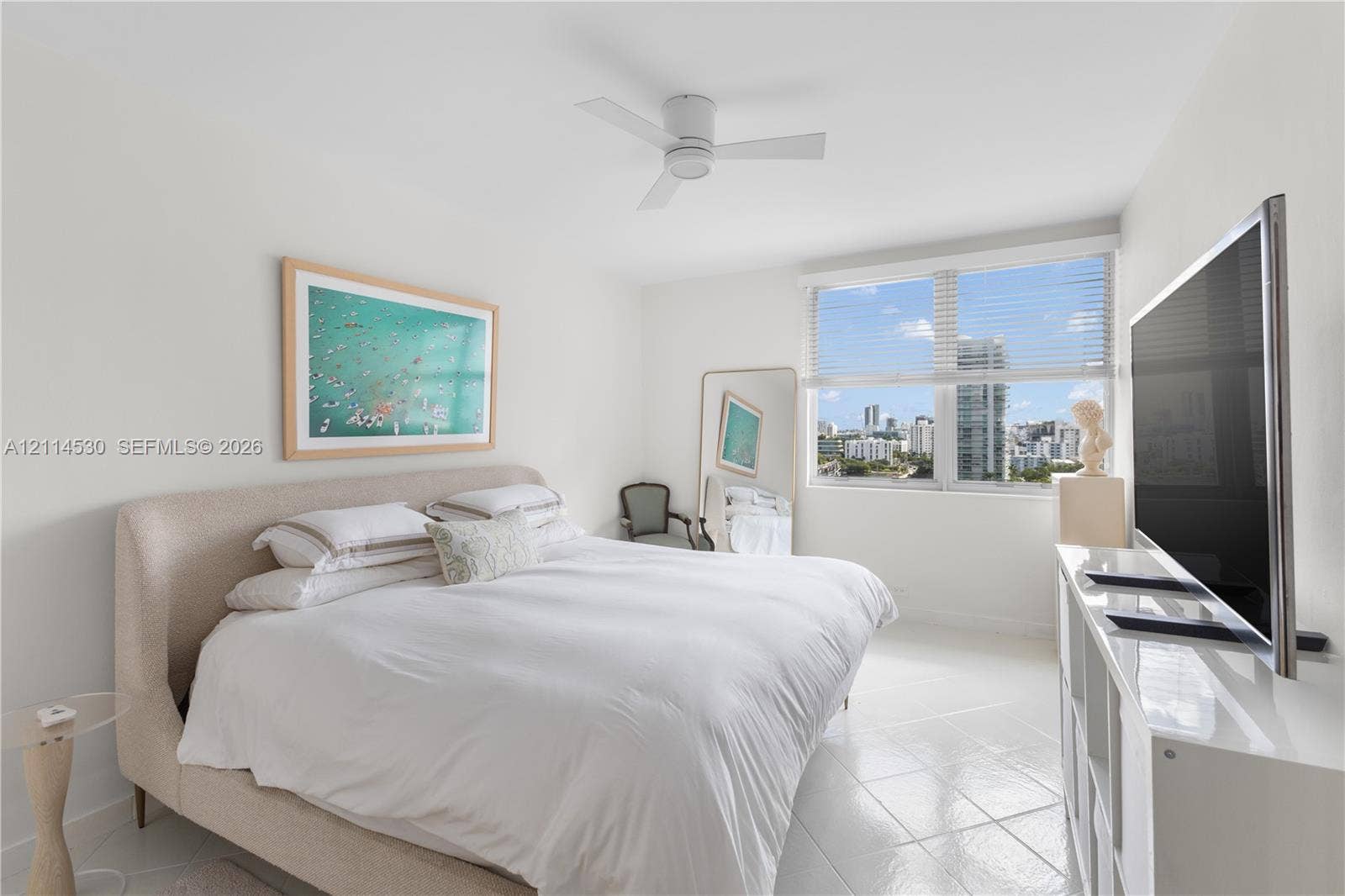 3 Island Avenue, #14L, Miami Beach, FL 33139 Bright room featuring large-format tile flooring, white-finish ceiling fan, and expansive window with horizontal blinds