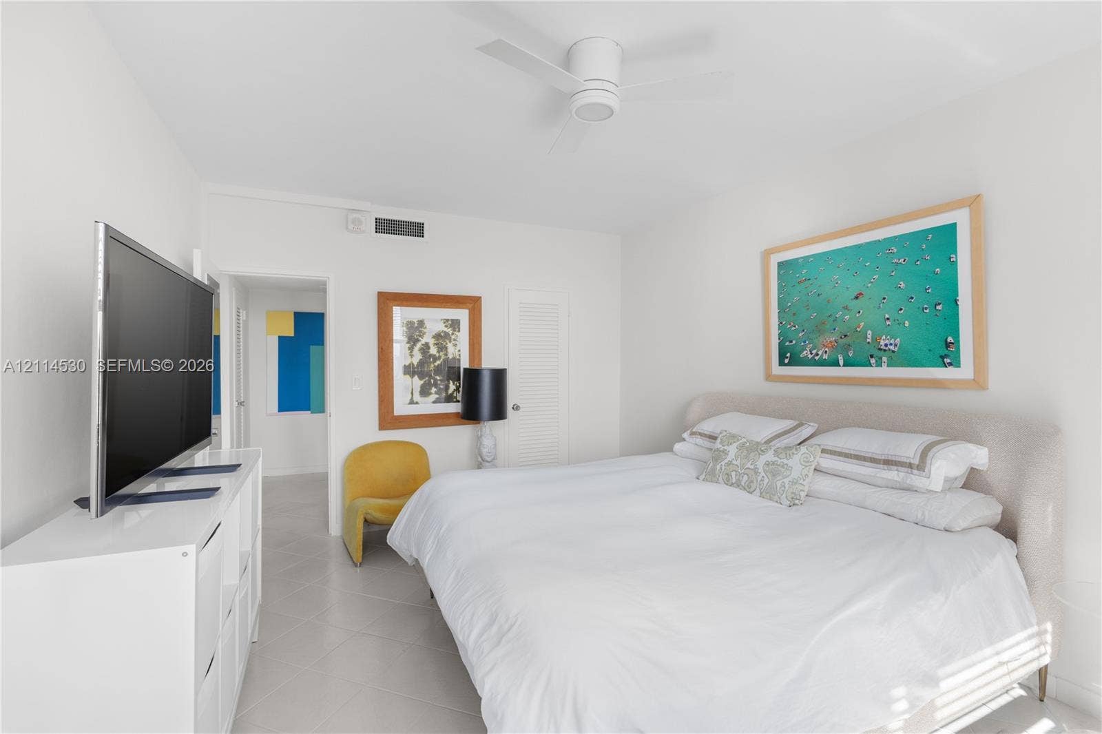3 Island Avenue, #14L, Miami Beach, FL 33139 Neutral-toned tile flooring, white-finished ceiling fan, and louvered closet door