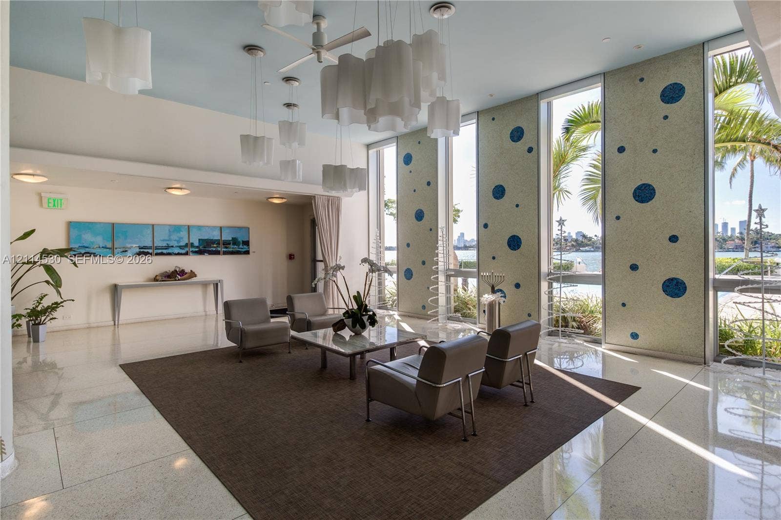3 Island Avenue, #14L, Miami Beach, FL 33139 Polished stone flooring, floor-to-ceiling windows, decorative custom mosaic wall panels, and tiered pendant lighting fixtures