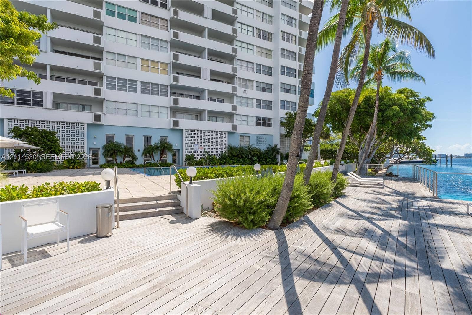 3 Island Avenue, #14L, Miami Beach, FL 33139 Waterfront terrace featuring wood-plank decking, a swimming pool, concrete stairs, and perimeter railings