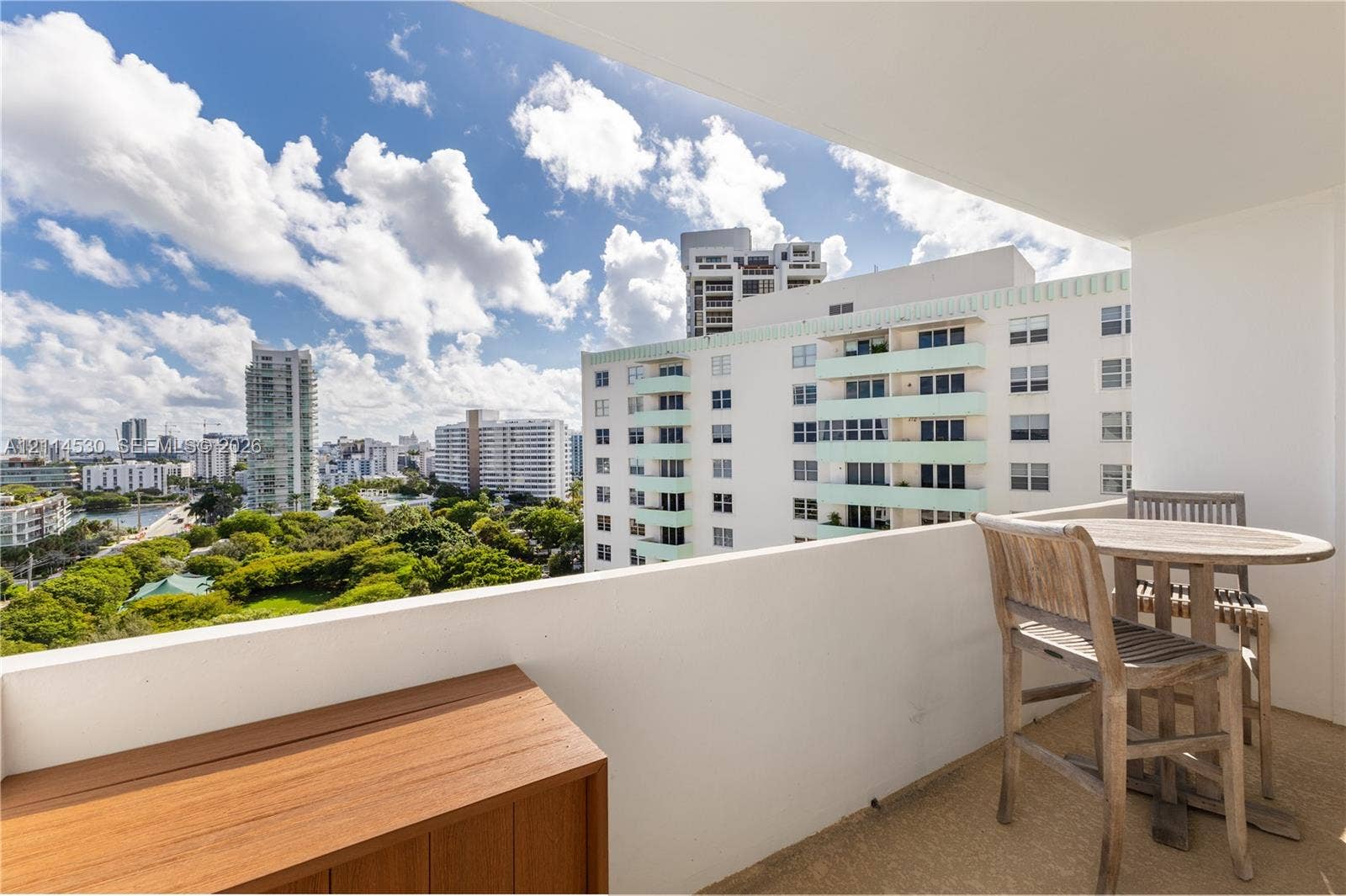 3 Island Avenue, #14L, Miami Beach, FL 33139 Private covered balcony with a solid waist-high wall and wood-finish cabinetry