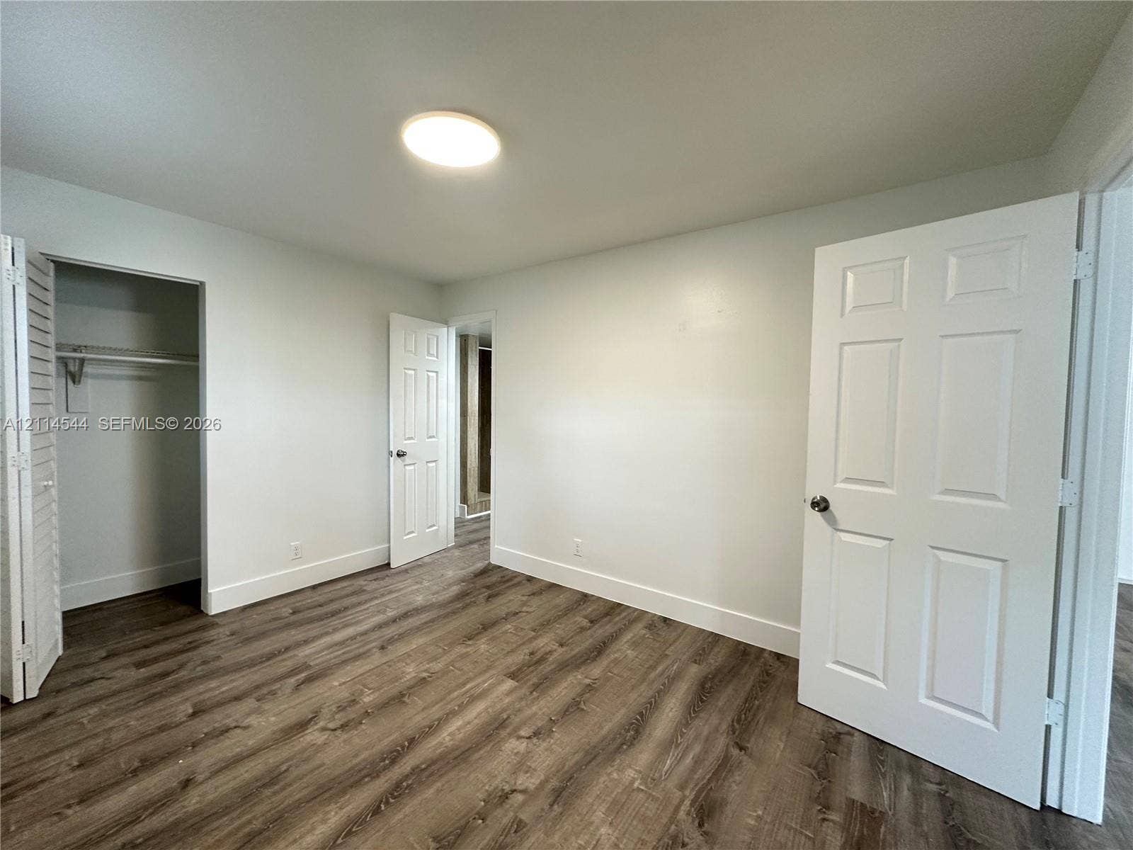 1413 N Dixie Highway, #3, Fort Lauderdale, Fort Lauderdale, FL 33304 Interior space featuring wood-finish flooring, six-panel interior doors, and a closet with louvered double doors