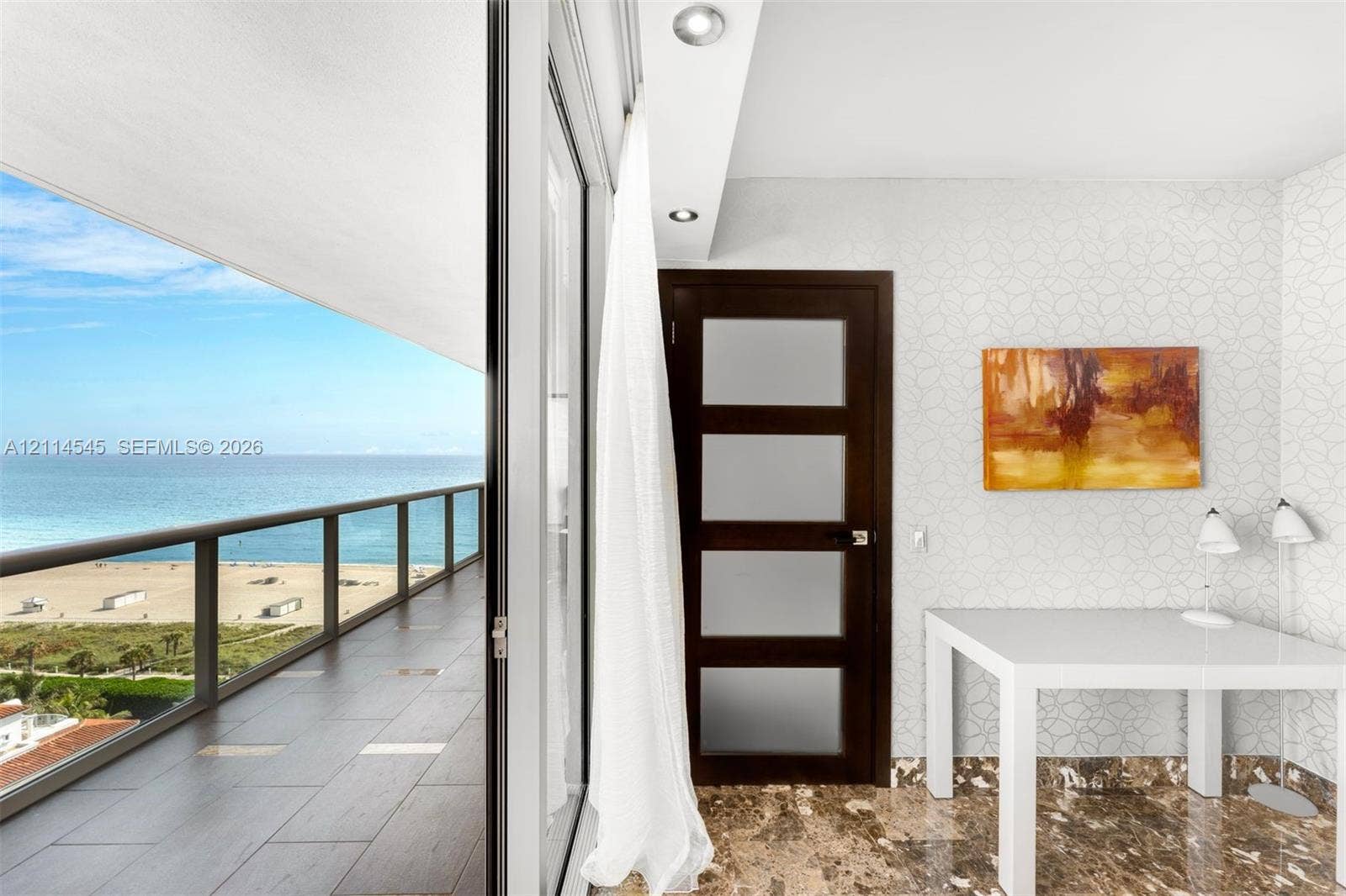 5875 Collins Avenue, #1503, Miami Beach, FL 33140 Expansive balcony with floor-to-ceiling glass sliding doors, dark tile flooring, glass panel railing, and ocean backdrop