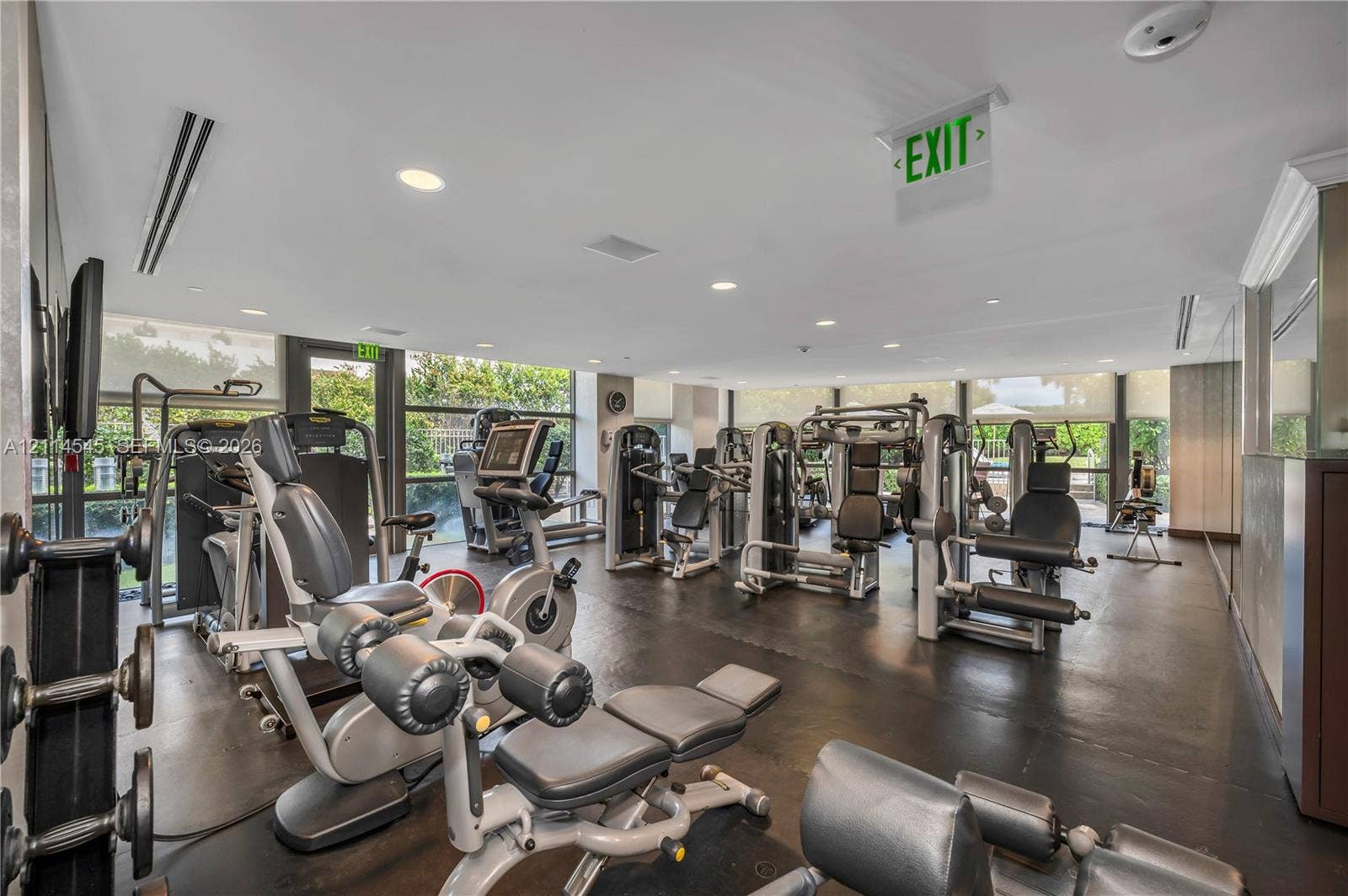5875 Collins Avenue, #1503, Miami Beach, FL 33140 Fitness center featuring rubberized flooring, mirrored walls, recessed lighting, and expansive floor-to-ceiling windows