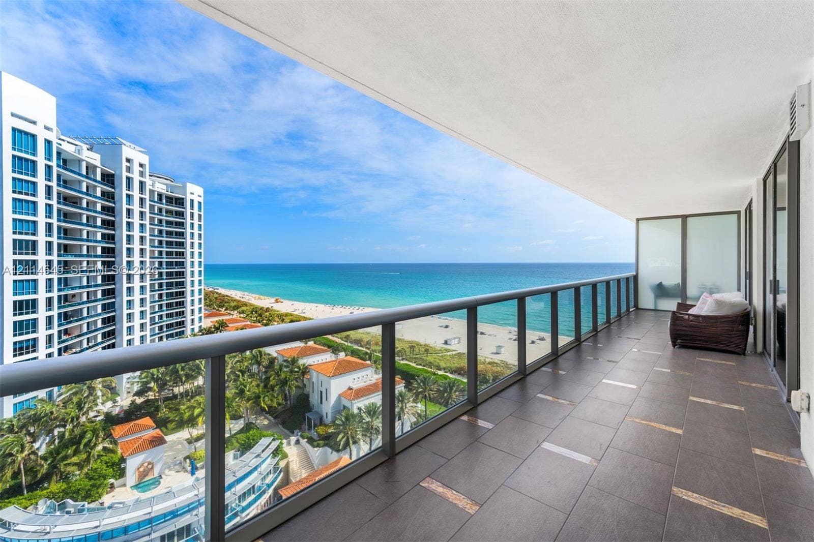 5875 Collins Avenue, #1503, Miami Beach, FL 33140 Spacious covered terrace featuring large-format porcelain tile flooring and metal-framed glass railings with ocean and coastal frontage