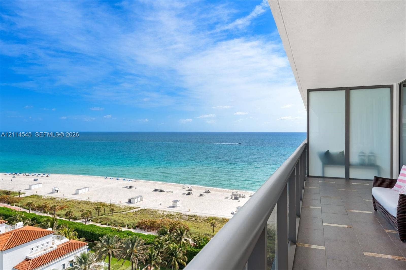 5875 Collins Avenue, #1503, Miami Beach, FL 33140 Covered balcony featuring tile flooring, metal railings, and frosted glass privacy screening