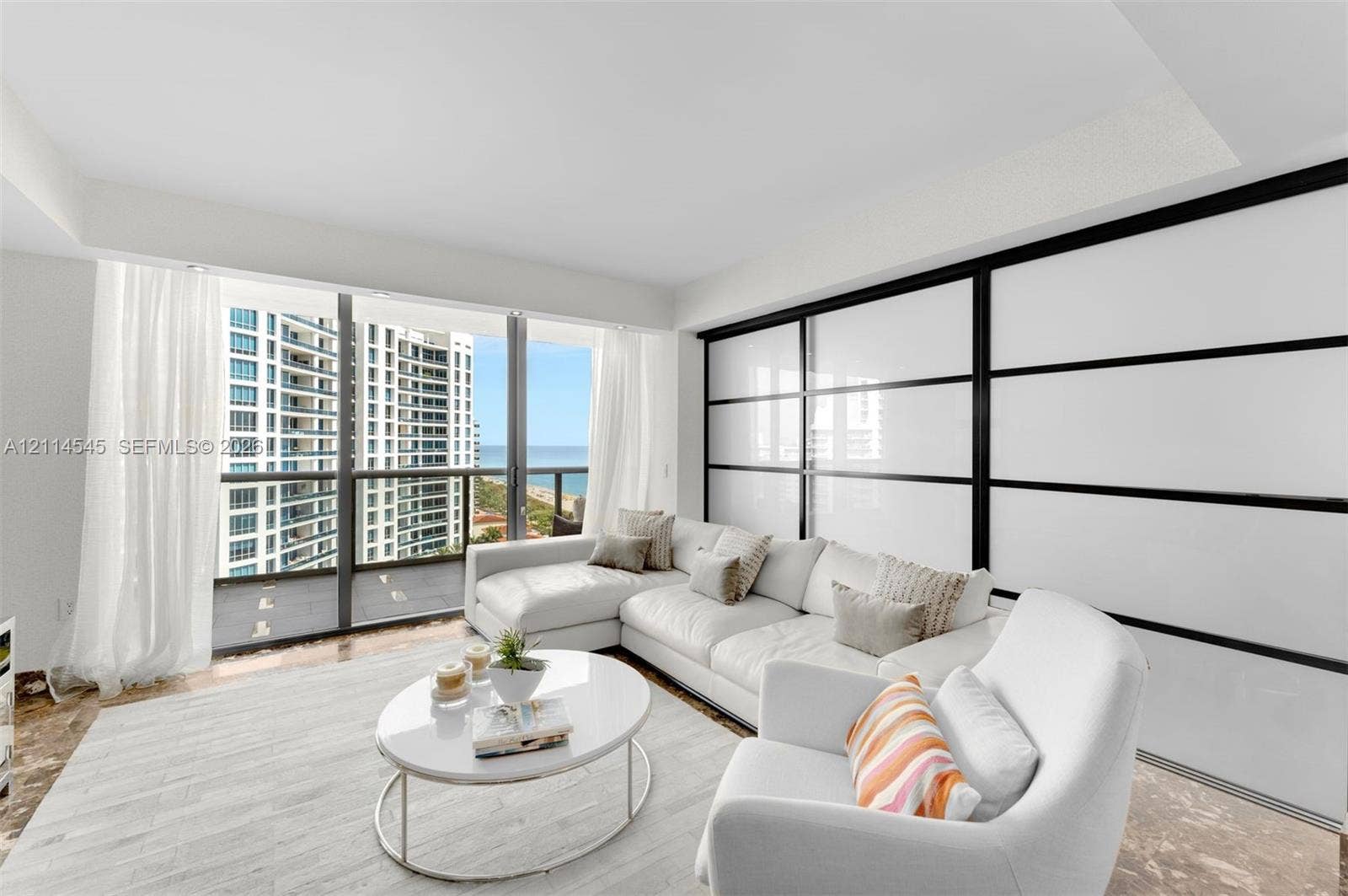 5875 Collins Avenue, #1503, Miami Beach, FL 33140 Floor-to-ceiling windows, oversized sliding glass balcony door, and large-format sliding wall panels with black metal framing