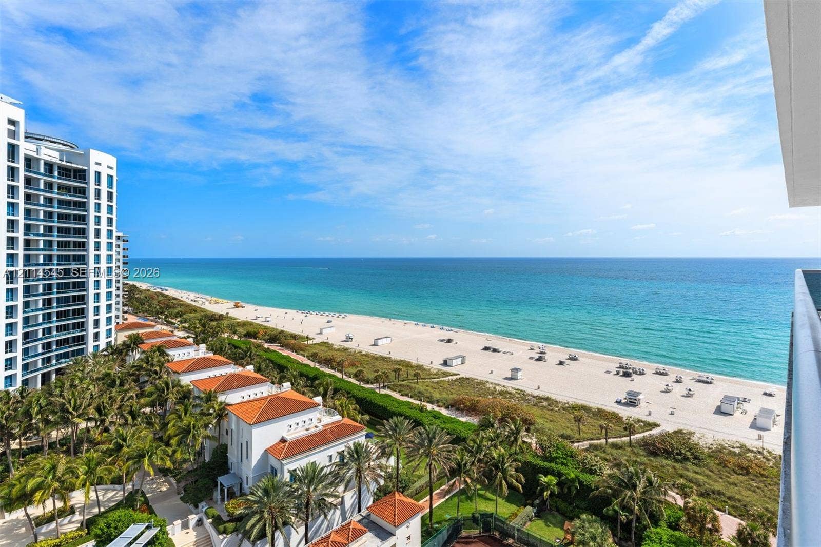 5875 Collins Avenue, #1503, Miami Beach, FL 33140 Panoramic coastal scenery featuring a direct expanse of ocean, white sand beach, tropical palm landscaping, and high-rise architecture