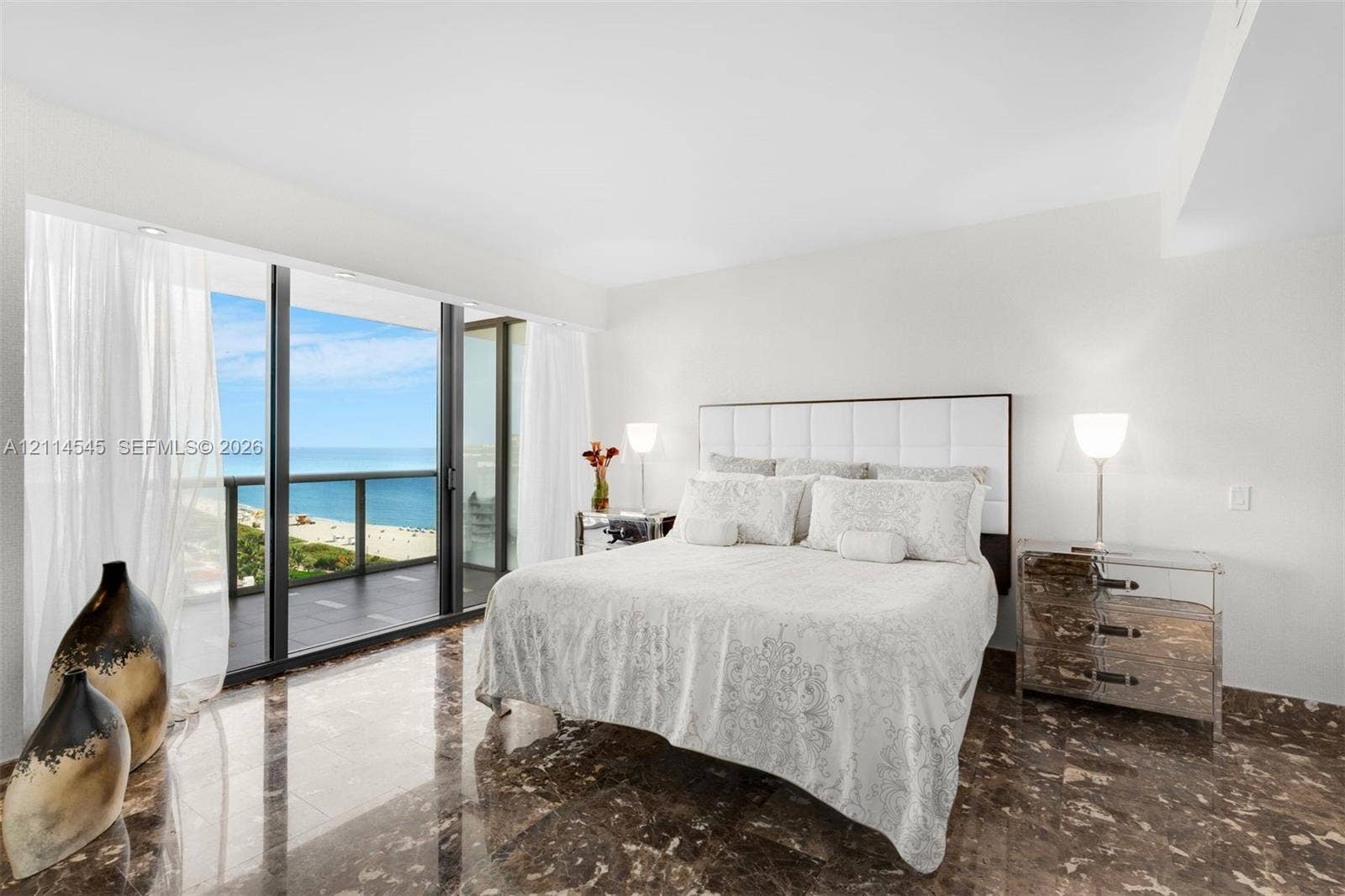 5875 Collins Avenue, #1503, Miami Beach, FL 33140 Floor-to-ceiling sliding glass doors, private balcony, polished stone flooring, and recessed ceiling lighting