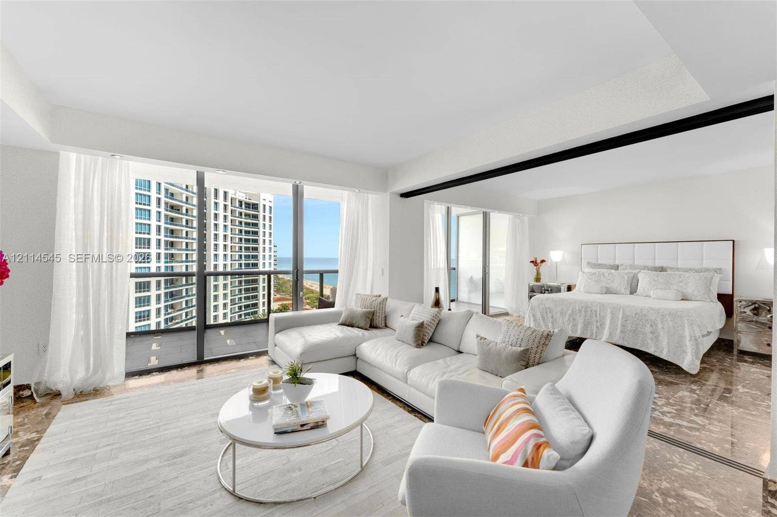 5875 Collins Avenue, #1503, Miami Beach, FL 33140 Floor-to-ceiling windows with coastal exposure, polished stone flooring, recessed ceiling lighting, and private balconies with glass railings