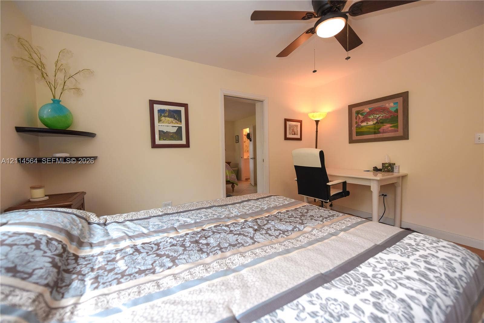 Room featuring a ceiling fan with integrated lighting and two floating wall shelves