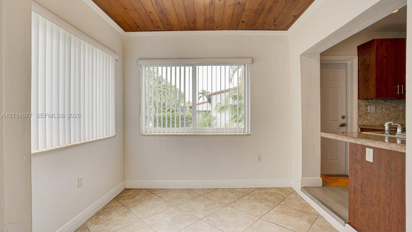 311 SW 38th Court, #0, Miami, Miami, FL 33134 Wood-plank ceiling, neutral tile flooring, and sliding windows with vertical blinds