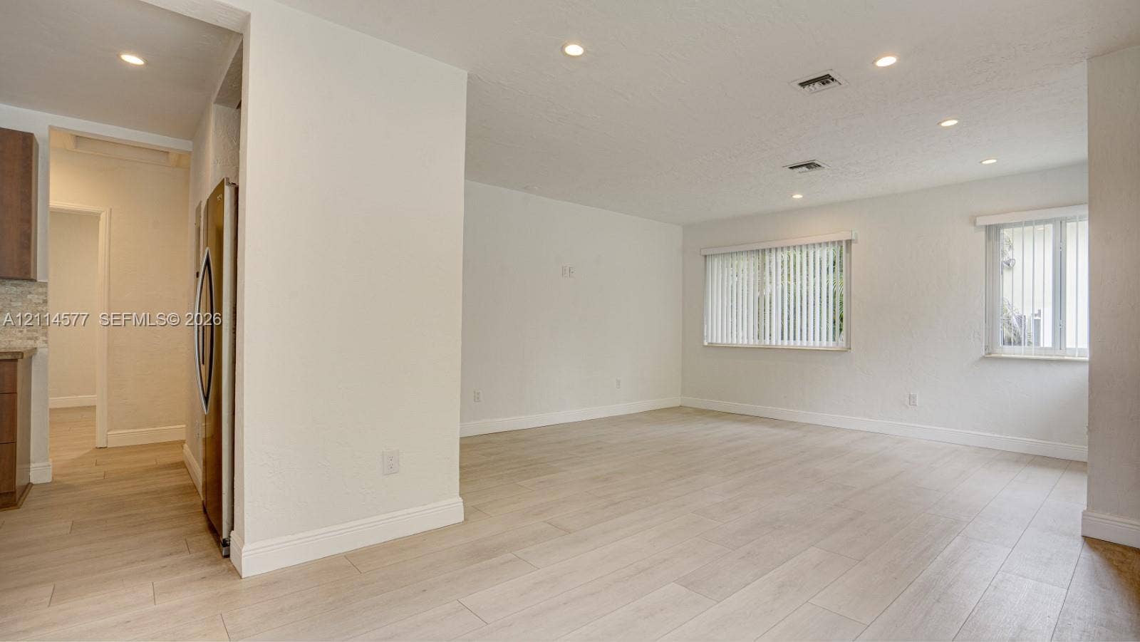 311 SW 38th Court, #0, Miami, Miami, FL 33134 Open living area featuring wood-finish flooring, recessed lighting, and windows with vertical blinds