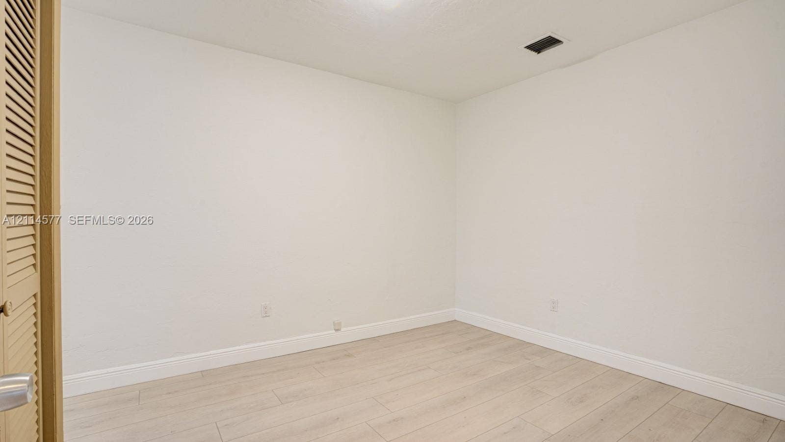 311 SW 38th Court, #0, Miami, Miami, FL 33134 Neutral interior space featuring wood-finish flooring and louvered closet doors