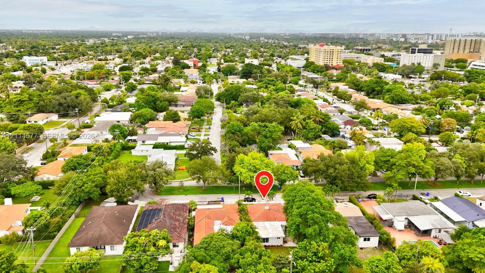 311 SW 38th Court, #0, Miami, Miami, FL 33134 Aerial perspective of a residential property featuring a tiled roof, mature canopy trees, and established landscaping