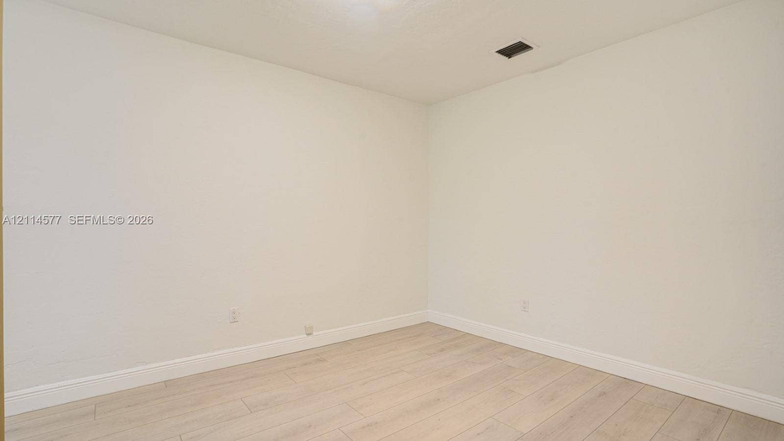 311 SW 38th Court, #0, Miami, Miami, FL 33134 Neutral-toned interior space featuring light-colored wood-finish flooring and smooth wall surfaces