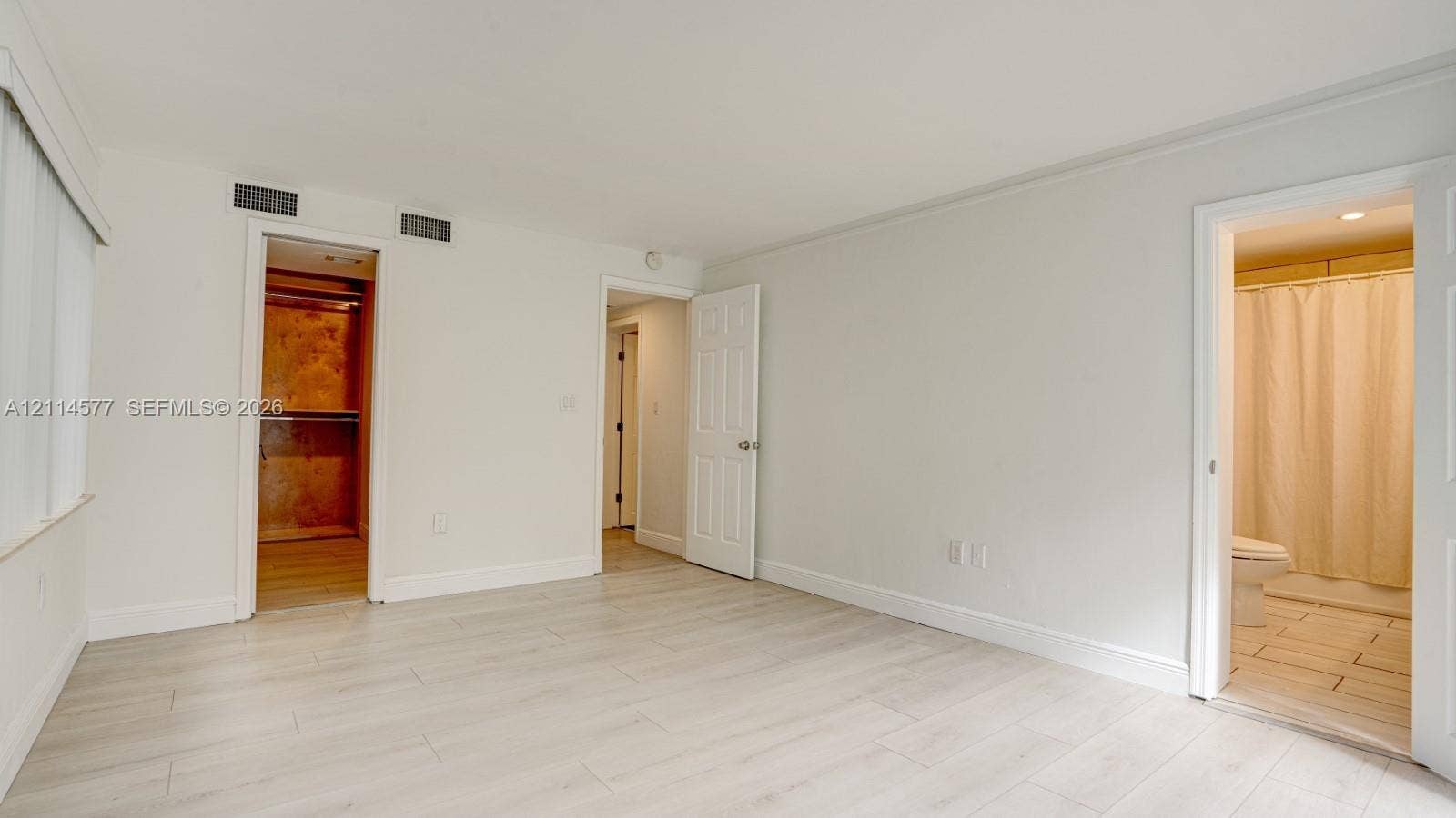 311 SW 38th Court, #0, Miami, Miami, FL 33134 Neutral interior space featuring wood-finish flooring, recessed walk-in closet, and attached full bathroom with tile flooring