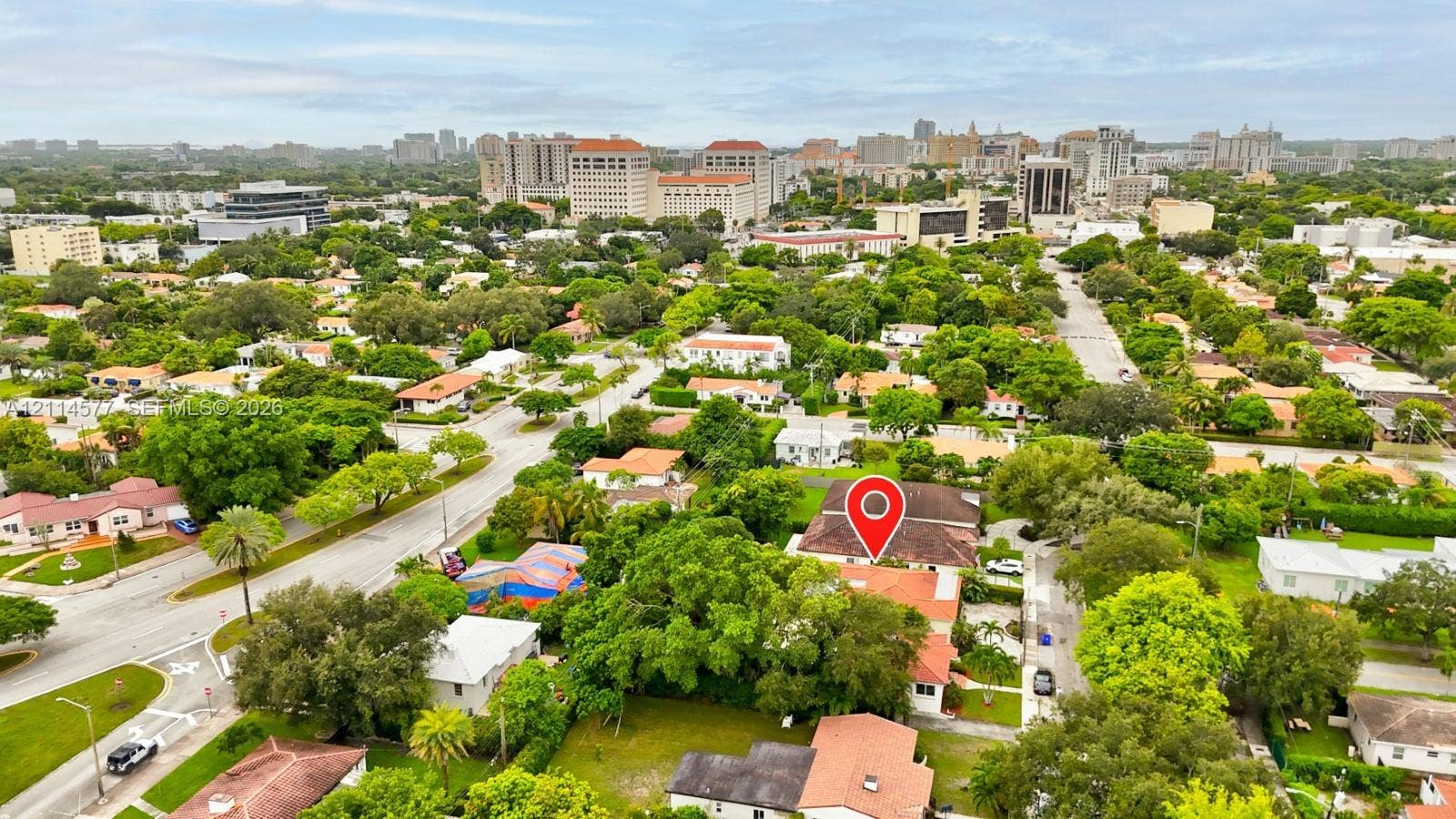 311 SW 38th Court, #0, Miami, Miami, FL 33134 Aerial perspective of a residential property featuring a pitched roof, mature canopy trees, established landscaping, and paved street access