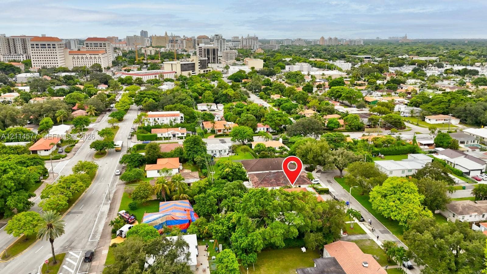 311 SW 38th Court, #0, Miami, Miami, FL 33134 Aerial perspective of a residential property featuring a hipped roof, mature canopy trees, and established landscaping within a dense urban corridor