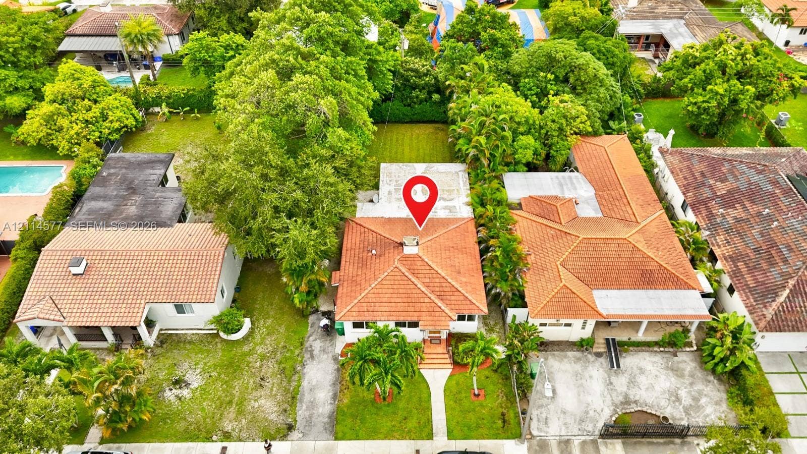 311 SW 38th Court, #0, Miami, Miami, FL 33134 Aerial perspective of a residence featuring a terracotta-tiled roof, concrete chimney, paved walkway, and mature landscaping