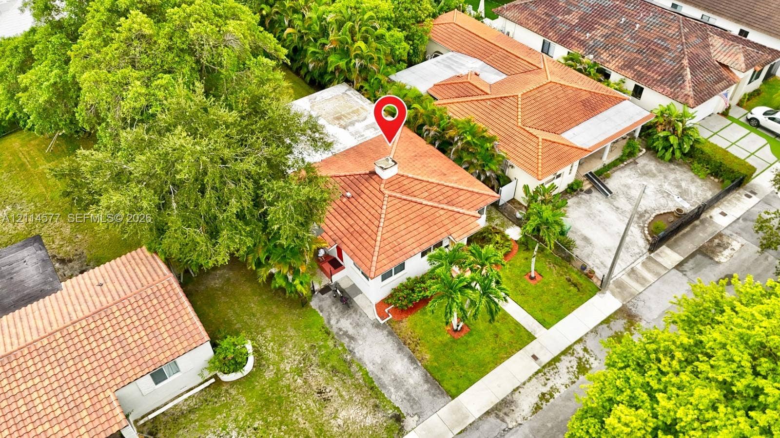 311 SW 38th Court, #0, Miami, Miami, FL 33134 Aerial perspective of a detached residence featuring a clay tile roof, concrete driveway, and mature landscaping