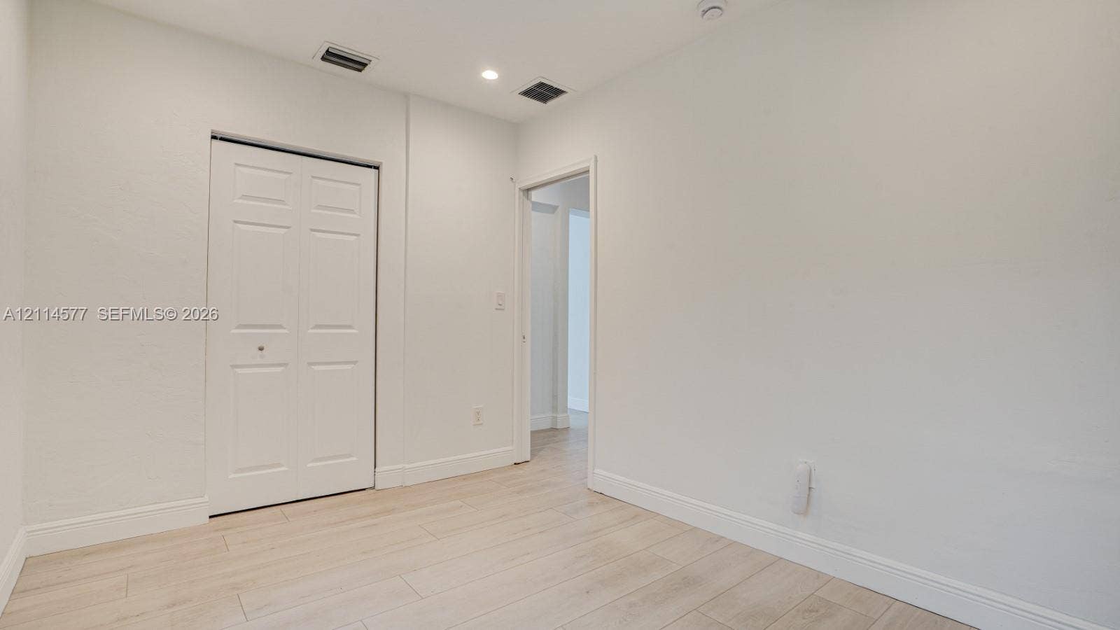 311 SW 38th Court, #0, Miami, Miami, FL 33134 Interior space featuring wood-finish flooring, white walls, and a closet with bifold doors