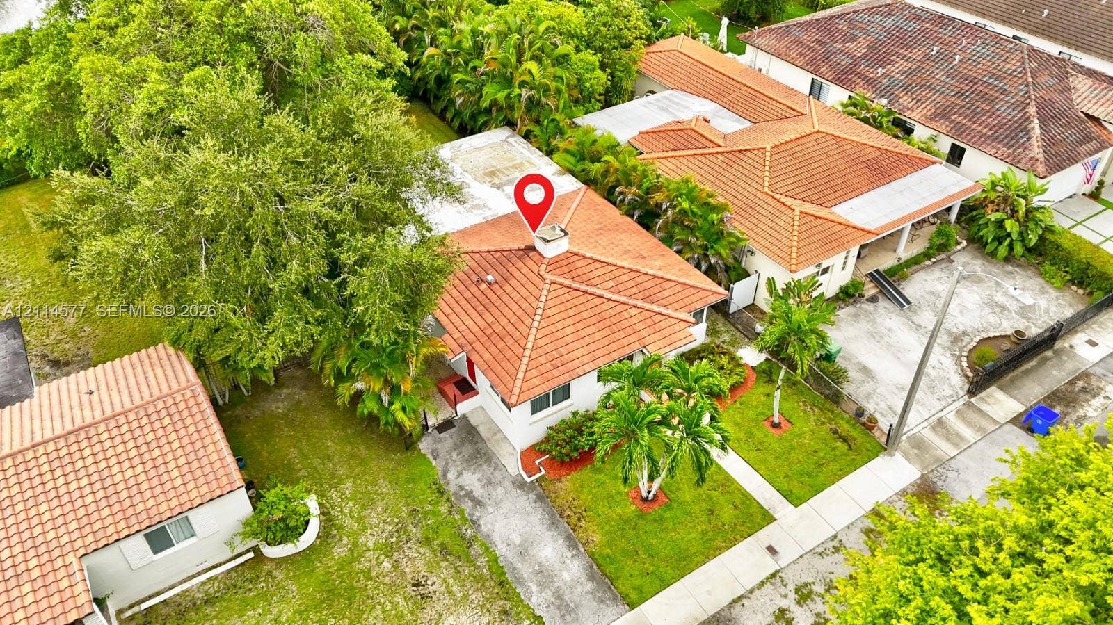 311 SW 38th Court, #0, Miami, Miami, FL 33134 Aerial view featuring a residence with a clay tile roof, white stucco exterior, prominent chimney, and surrounding mature landscaping
