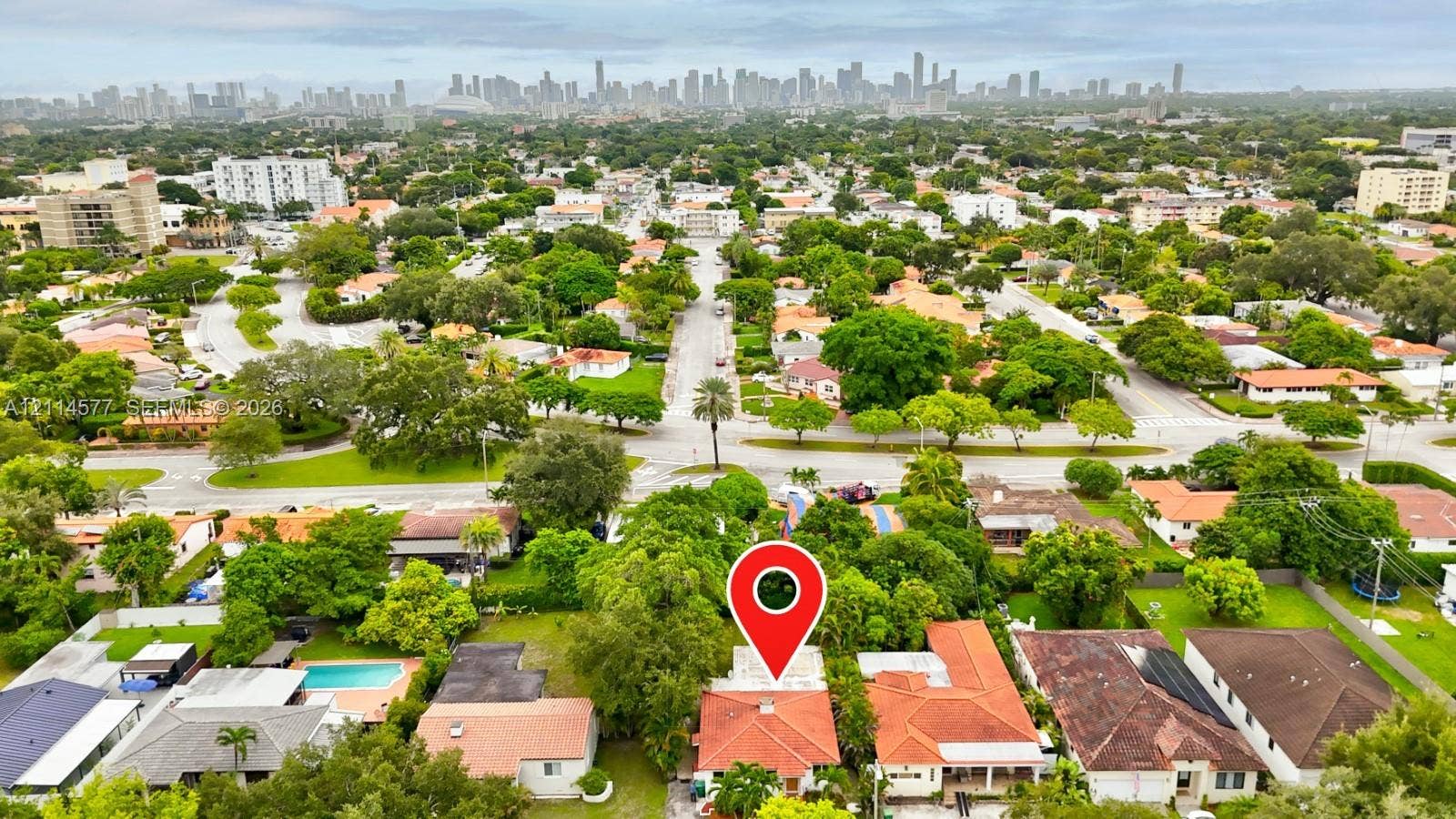 311 SW 38th Court, #0, Miami, Miami, FL 33134 Aerial perspective featuring an orange-tiled roofline and a prominent urban skyline backdrop