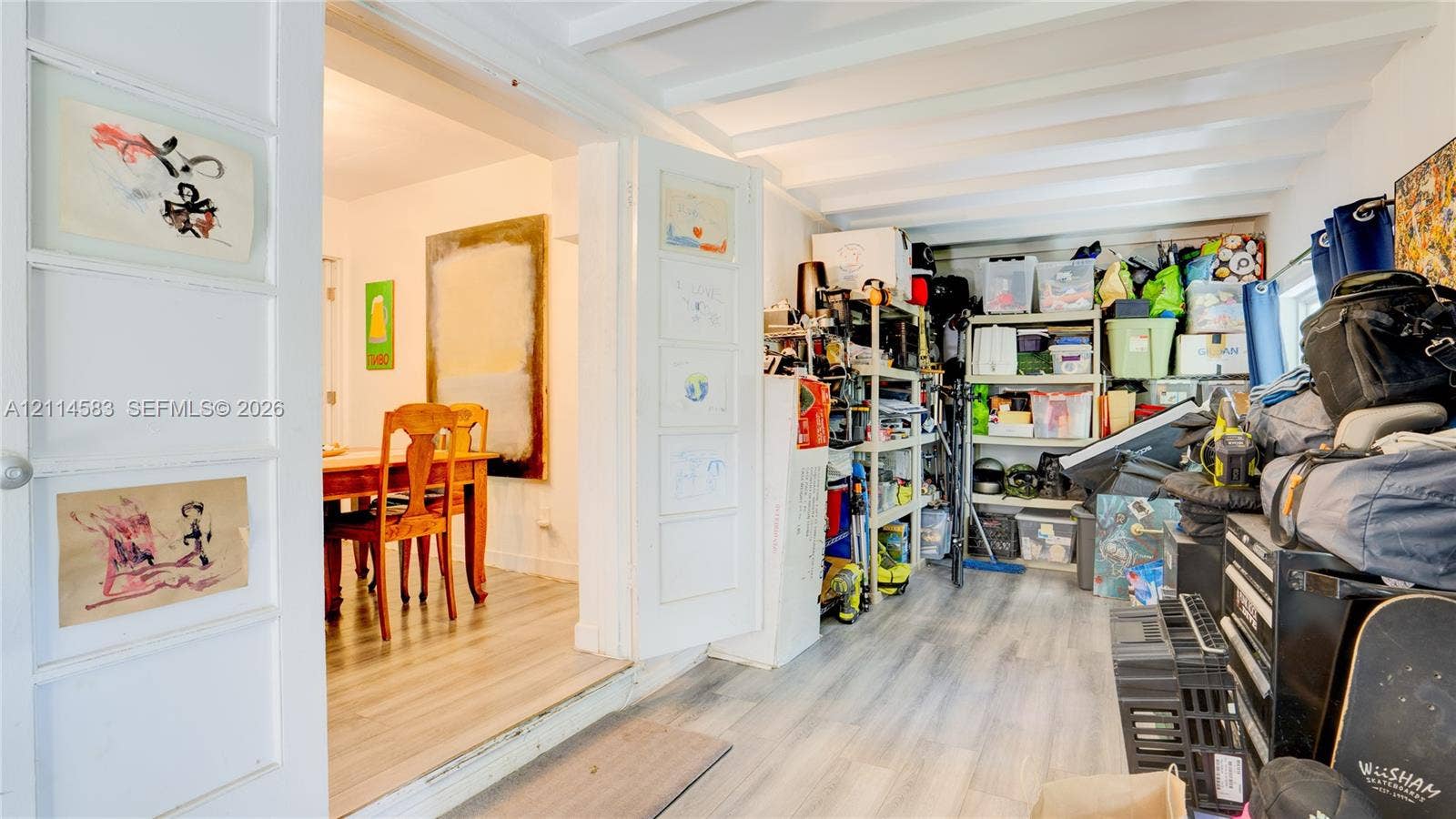 13301 NW Miami Court, Miami, FL 33168 Wood-finish flooring, exposed ceiling beams, and multi-panel swinging interior doors