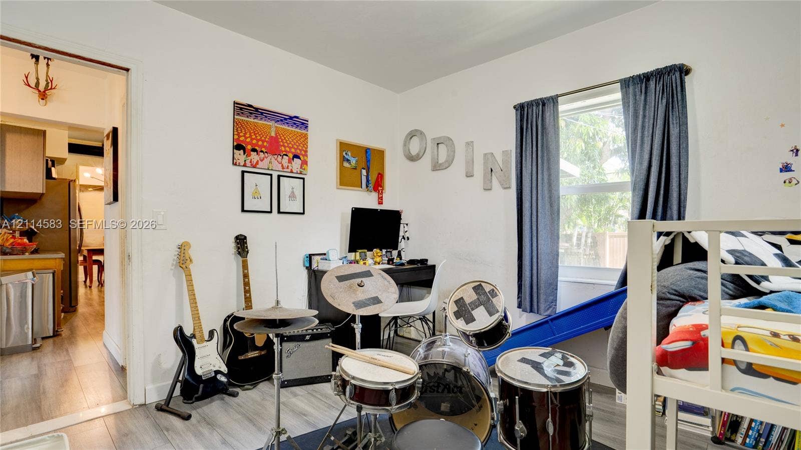 13301 NW Miami Court, Miami, FL 33168 Room featuring neutral wall finishes, wood-finish flooring, and a single-pane window