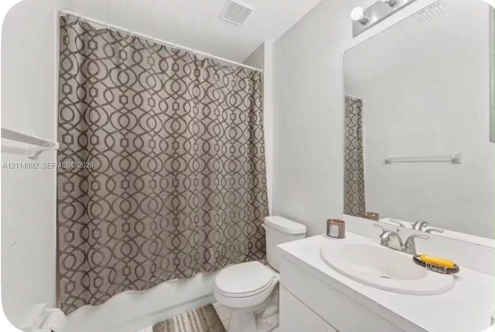 12230 Dartmoor Drive, Wellington, FL 33414 Bathroom featuring a white vanity with an integrated oval sink, chrome faucet, wall-mounted mirror, and a tub-shower combination